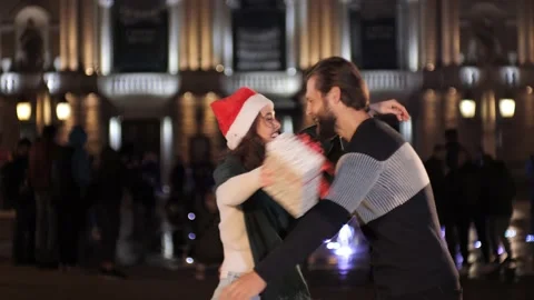 Guy makes a present to his girlfriend for Christmas and then hugs Happy New year Video stock 142233932