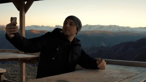 Guy makes selfi in the mountains Stock Footage 98451000