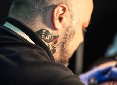 Guy is making tattoo, in a studio. Stock Photos