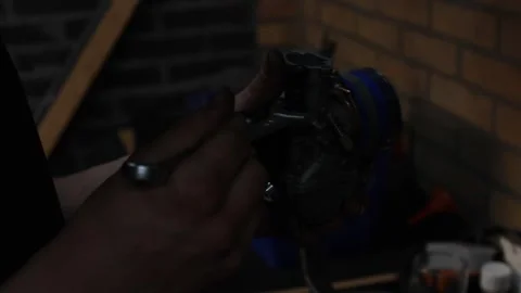 Guy, man, boy, mechanic working on a motorcycle, bike dark cinematic style Stock Footage 282511762