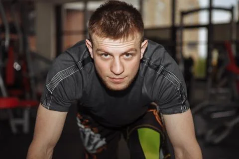 Guy, man, coach, in the gym is squeezed off the floor, doing sports, warming up Stock Photos