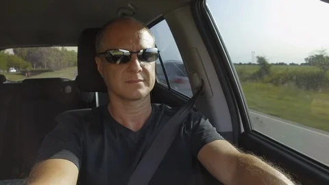 Guy Man Driving a car SUV on a Country side Road, green rural valley. Sunny day Stock Footage 123254332