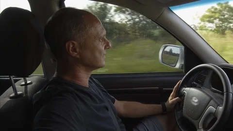 Guy Man Driving a car SUV on a Country side Road, green rural valley. Sunny day Stock Footage 123255329