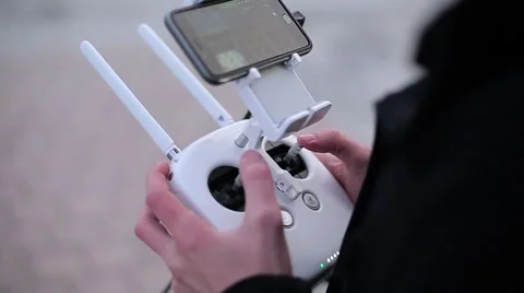 Guy manages drone via remote close up Stock Footage 61431086