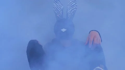 The guy in the mask of a hare. the guy in the haze. the guy shakes his head Stock Footage 166399276