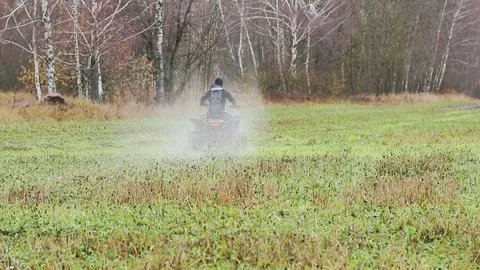 The guy with the mask on her face riding her ATV Stock Footage 82580949