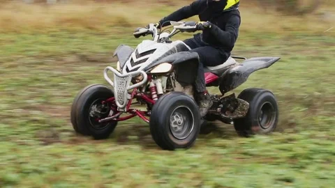 The guy with the mask on her face riding her ATV Stock Footage 82584510