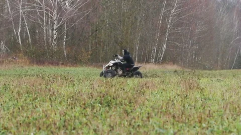 The guy with the mask on her face riding her ATV Stock Footage 82589923