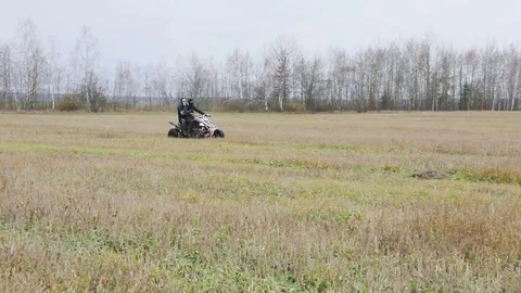 The guy with the mask on her face riding her ATV Stock Footage 82594939