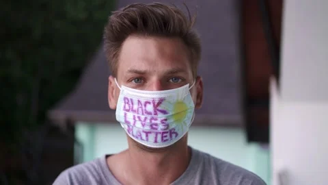 A guy in a mask on his face with the words "Black Life Matters" Stock Footage 154807146