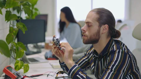 Guy Master Checking, Looking at the Electronic Device. Man Holding, Working with Video stock 250601676