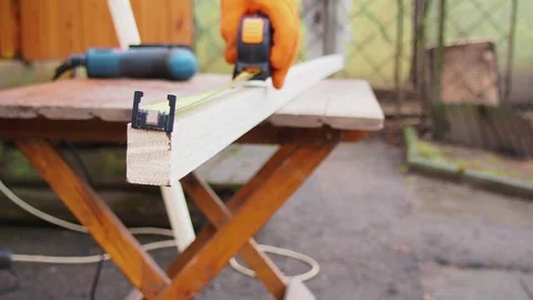 The guy measures the length of the board with a tape measure Stock Footage 187157224