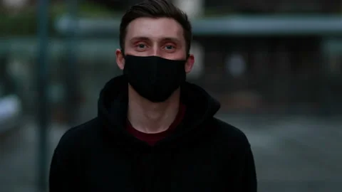 A guy in a medical mask walks down the street Stock Footage 130129035