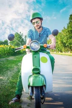 The guy in the middle of the road winds his retro scooter Stock Photos