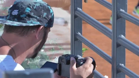 Guy with a mirrorless camera filming from behind  Stock Footage 141605522