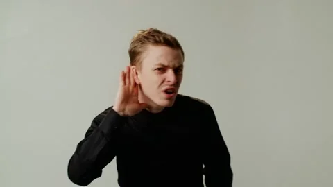 A guy misunderstands interlocutor due to poor hearing or pretends deaf for Stock Footage 253258280