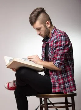 Guy with mohawk reading a book Stock Photos