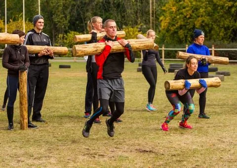 The guy at the moment of the jump with a log. Stock Photos