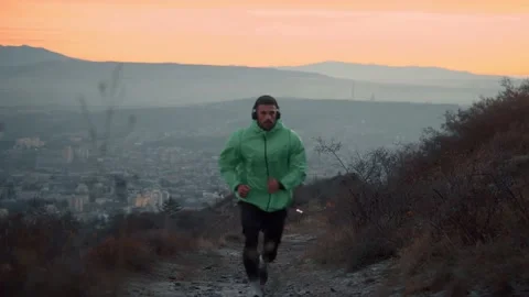 The guy on a morning run in the park on a background of trees Video stock 239552186