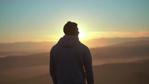 The guy on a morning run standing at the top of mountains . Stock Footage 239555980