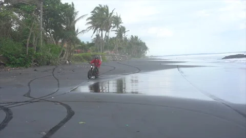 Guy on a motorcycle on the ocean Stock Footage 131099066