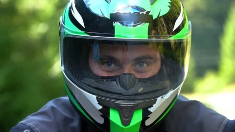 A guy on a motorcycle. Young handsome guy with his motorcycle in the mountains Stock Footage 95907675