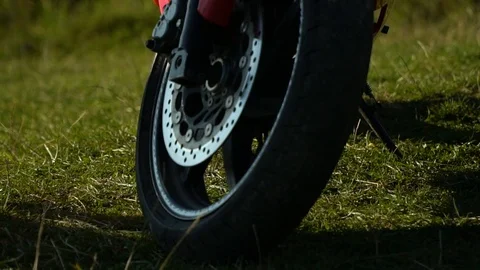 A guy on a motorcycle. Young handsome guy with his motorcycle in the mountains Stock Footage 95971320