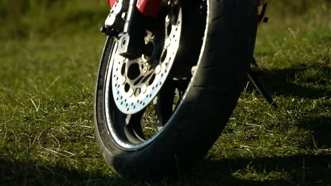 A guy on a motorcycle. Young handsome guy with his motorcycle in the mountains Stock Footage 95971510