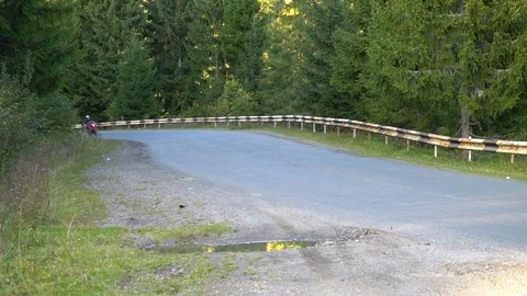 A guy on a motorcycle. Young handsome guy rides a motorcycle on a mountain road. Stock Footage 96044543