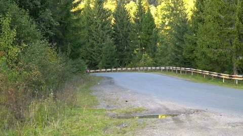 A guy on a motorcycle. Young handsome guy rides a motorcycle on a mountain road. Stock Footage 96152691