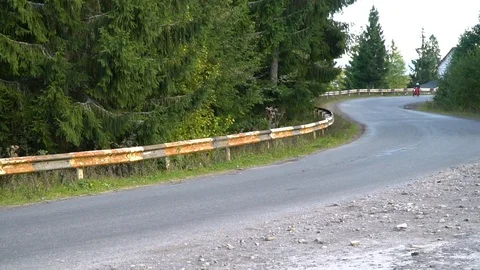 A guy on a motorcycle. Young handsome guy rides a motorcycle on a mountain road. Stock Footage 96152850