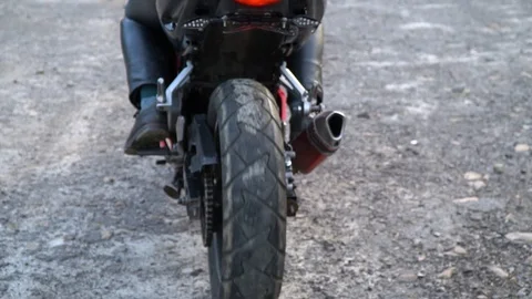 A guy on a motorcycle. Young handsome guy rides a motorcycle on a mountain road. Stock Footage 96153107