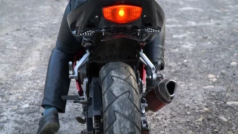 A guy on a motorcycle. Young handsome guy rides a motorcycle on a mountain road. Stock Footage 96153256