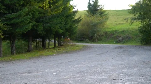 A guy on a motorcycle. Young handsome guy rides a motorcycle on a mountain road. Stock Footage 96153297