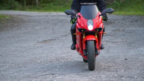 A guy on a motorcycle. Young handsome guy rides a motorcycle on a mountain road. Stock Footage 96153664