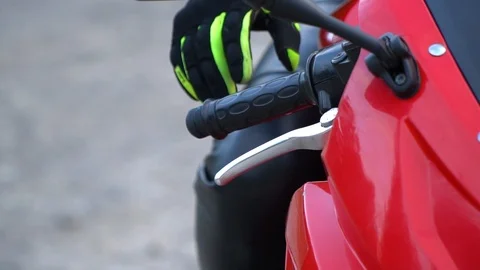 A guy on a motorcycle. Young handsome guy with his motorcycle in the mountains Stock Footage 96153793