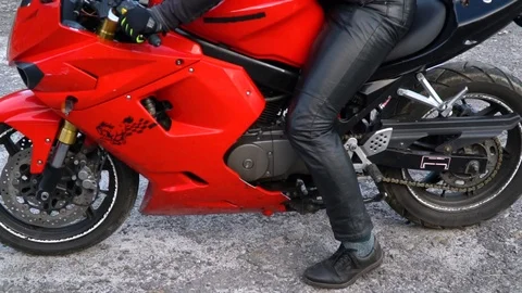 A guy on a motorcycle. Young handsome guy with his motorcycle in the mountains Stock Footage 96154174