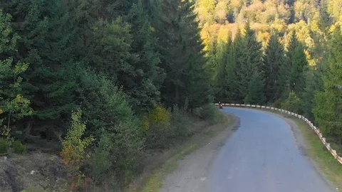 A guy on a motorcycle. Young handsome guy rides a motorcycle on a mountain road Stock Footage 96155752