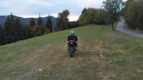 A guy on a motorcycle. Young handsome guy rides a motorcycle on a mountain road Stock Footage 96156524