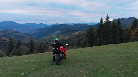 A guy on a motorcycle. Young handsome guy rides a motorcycle on a mountain road Stock Footage 96156713