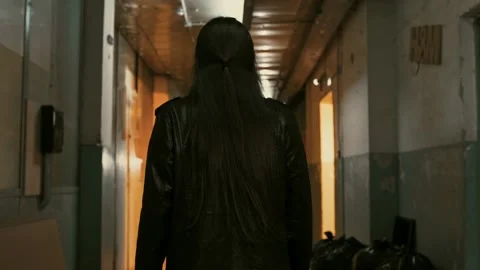 Guy  moves through the corridor of a dark sub-building. Stock Footage 287915366