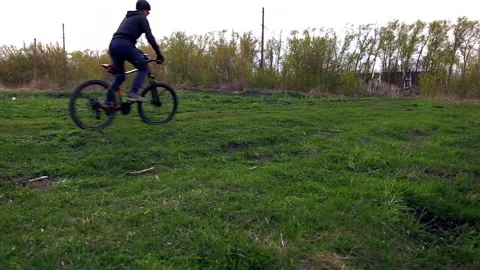 A guy in navy blue clothes, a helmet and bicycle gloves drives through the c Stock Footage 153467579
