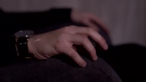 The guy is nervous. Shaking hand, leg. He takes up his head. Stock Footage 130229837