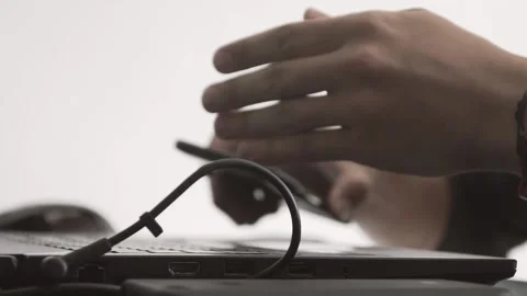 The guy in the office. The guy is working. The guy behind the phone and laptop Stock Footage 130730123