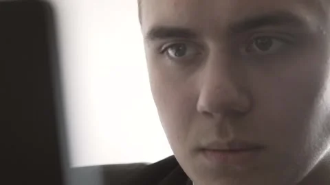 The guy in the office. The guy is working. The guy behind the phone and laptop Stock Footage 130730211