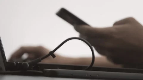 The guy in the office. The guy is working. The guy behind the phone and laptop Stock Footage 130730629