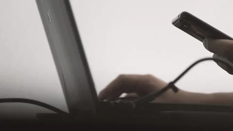 The guy in the office. The guy is working. The guy behind the phone and laptop Stock Footage 130730648