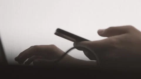 The guy in the office. The guy is working. The guy behind the phone and laptop Stock Footage 130730670