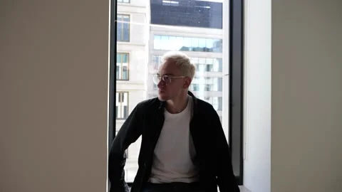 The guy in the office is standing by the window Stock Footage 138874398