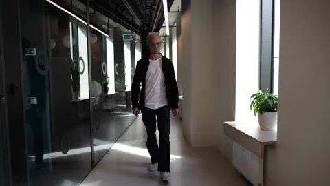 The guy in the office is standing by the window Stock Footage 138874416